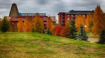 Beautiful park with buildings, colorful hill and plants in Finland