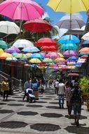 walking street with hanging umbrellas