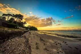 sunset over the tropical beach by the ocean