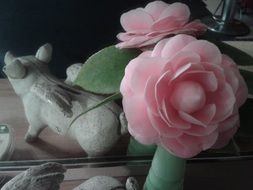 rose and winged pig figure at mirror