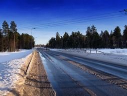 road near the coniferous forest in Finland