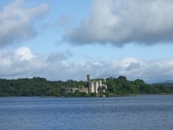 Distant view of a castle near a lake in ireland