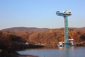 tower on the lake for bungee jumping on a sunny day