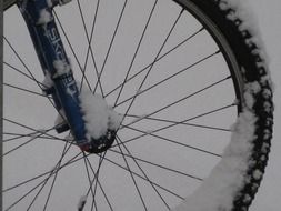 snow on wheel of mountain bike