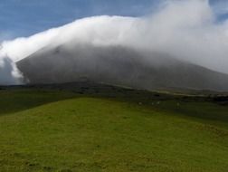 white cloud on green mountain