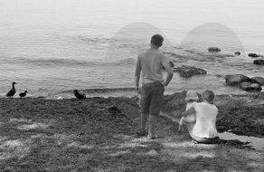 family, parents with child at water