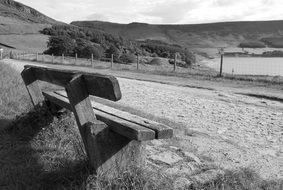 bench near the fence in black-white background