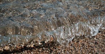 clear wave splashing on sand beach