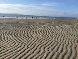 wave in the sand on the beach at low tide