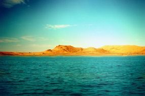 blue sea and yellow mountain sunny scene