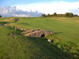 stone wall around golf course at spring