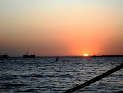 ships on the sea at sunset