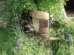 old rusty tractor in greenery