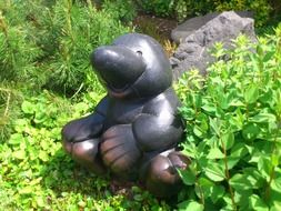 Garden statue near green plants