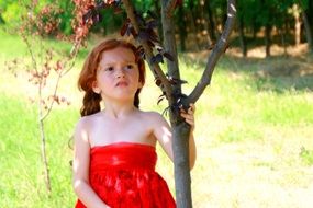red with red hair in red dress in the forest
