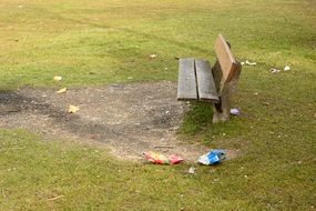 Wooden bench in park garbage