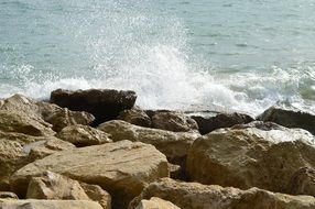 White spray sea waves rocks