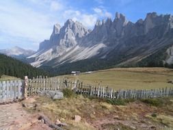 wooden fence at the foot of the picturesque Alps