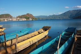 long wooden boats on lugu lake in china