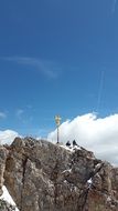 Beautiful summit cross on beautiful Zugspitze with snow in OstallgÃ¤u, Germany