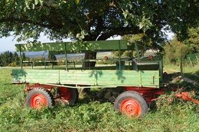 colorful trailer beneath tree in countryside, austria, kremser