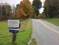 mailbox on the edge of a rural road in the autumn landscape