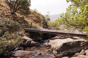 wooden bridge over the rocky river