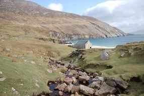 rural house in the mountains on the banks of the reservoir