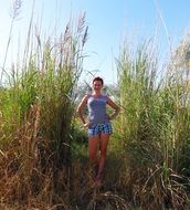 girl in blue t-shirt and shorts on the field