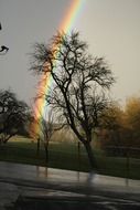 rainbow over wet highway in the rain
