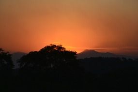 silhouettes of a landscape on the background of a bright sunset