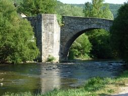 old stone bridge over a river of town