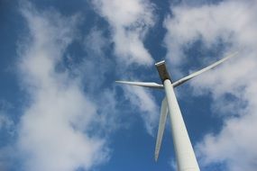 windmill on a background of blue sky with clouds