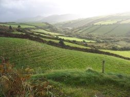 landscape of green fields on a hill in Ireland