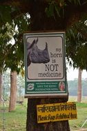 signs prohibiting poaching on rhinos in Nepal