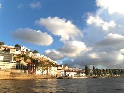 port on the shore under the blue sky with white clouds