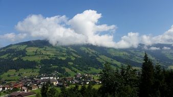 white clouds over green mountains in Austria