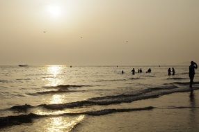 people on the beach seeing off sunset