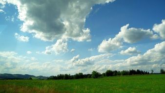 green fields landscape with clouds