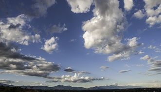 landscape of distant mountains and white clouds on the blue sky