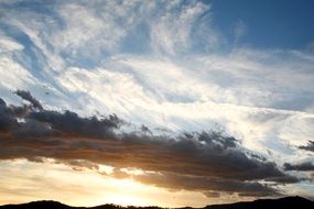 clouds with yellow glow on the horizon during sunset