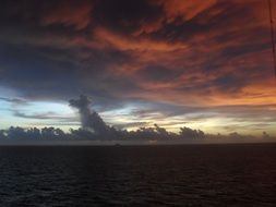 dark clouds with yellow overflow over the coast