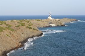 lighthouse on the ocean coast under the sky