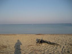 mountain bike in fourka beach with man shadow