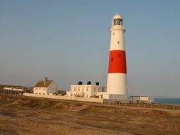 red-white lighthouse on the ocean coast