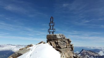 metal cross on top of a mountain under the sky, val venosta