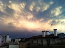 cozy roofs of houses at sunset