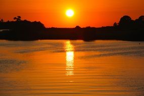 orange sunset above calm gulf, usa, florida