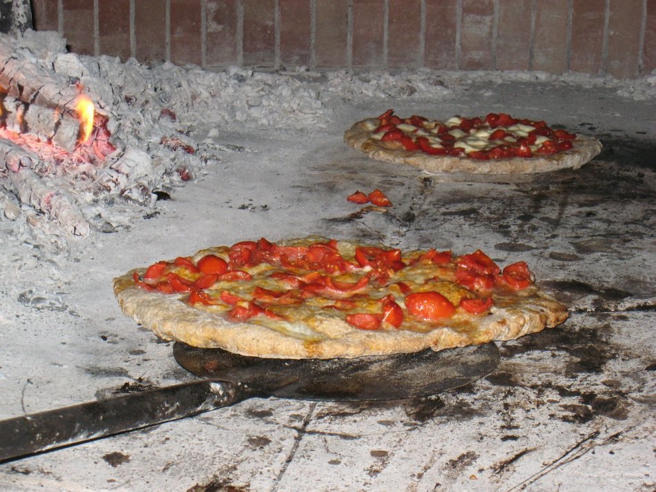 pizza with tomatoes in the oven