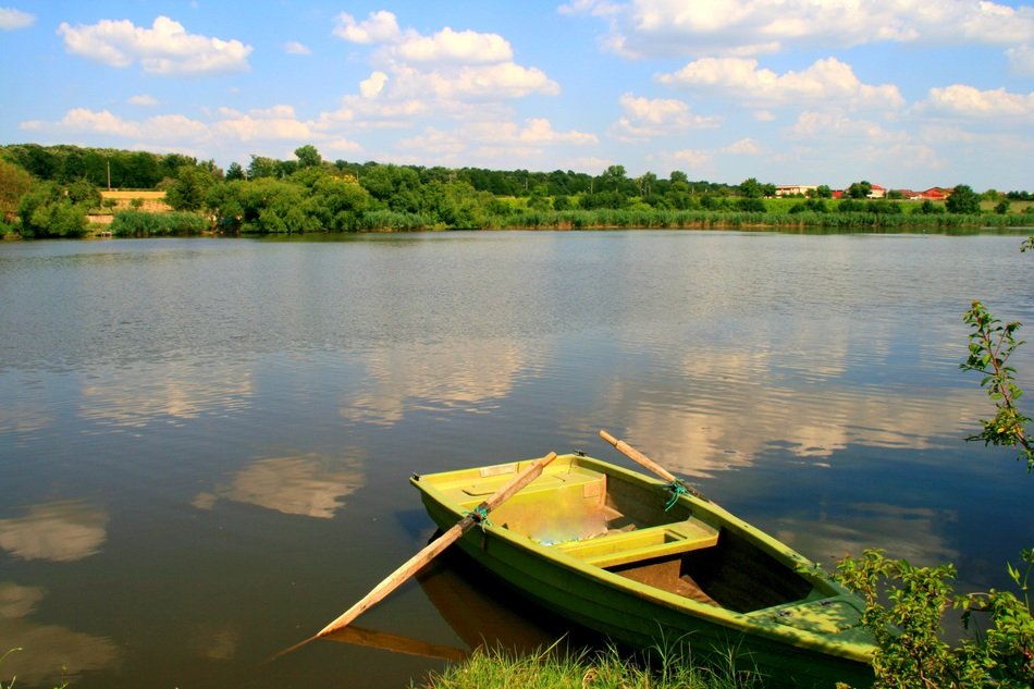 wooden boat on the water on the lake